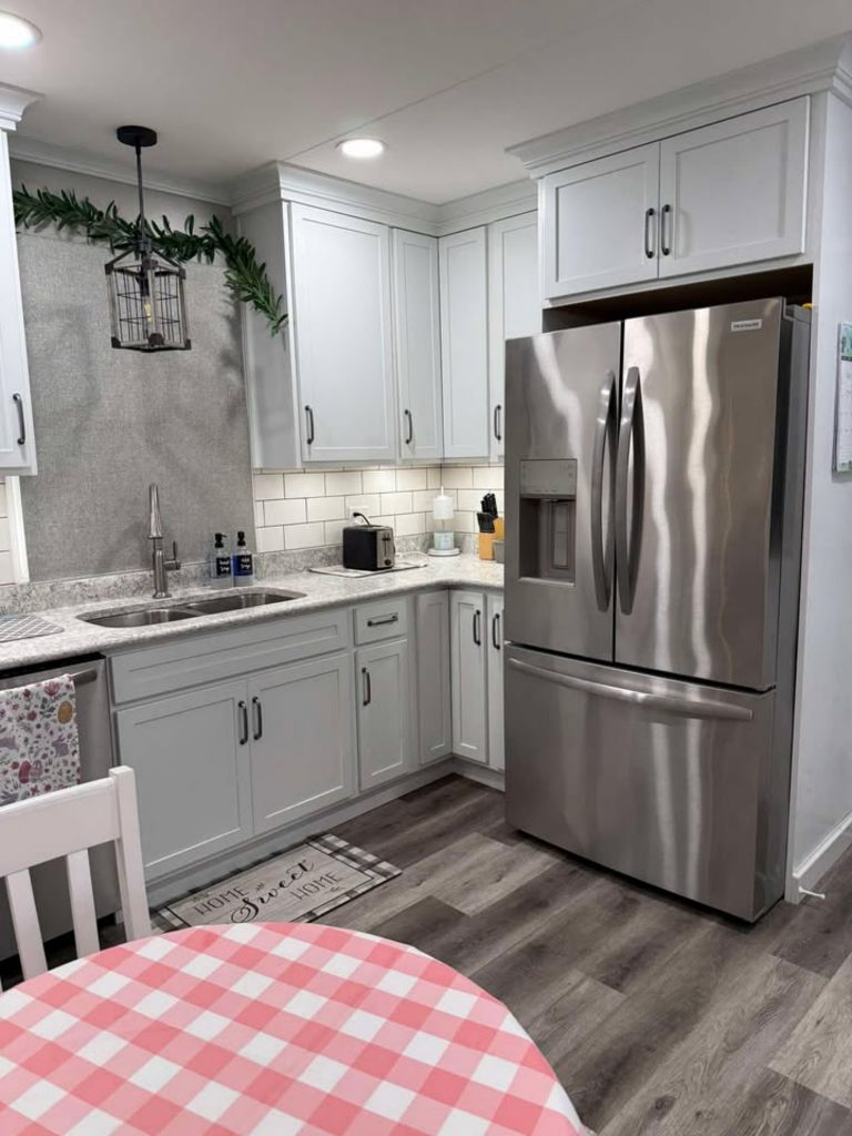 KraftMaid Lyndale maple cabinetry in Dove White with classic 5-piece drawer fronts, paired beautifully with Viatera Everest quartz countertops